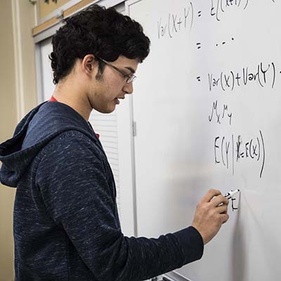 A Washburn students works on an equation during a math class in Morgan Hall.