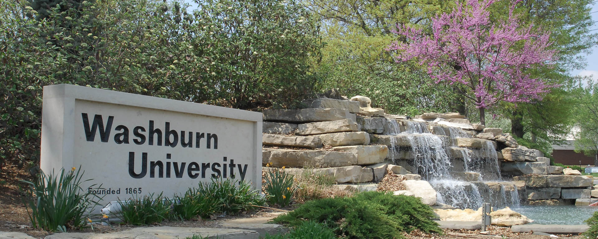 Washburn University sign by waterfall