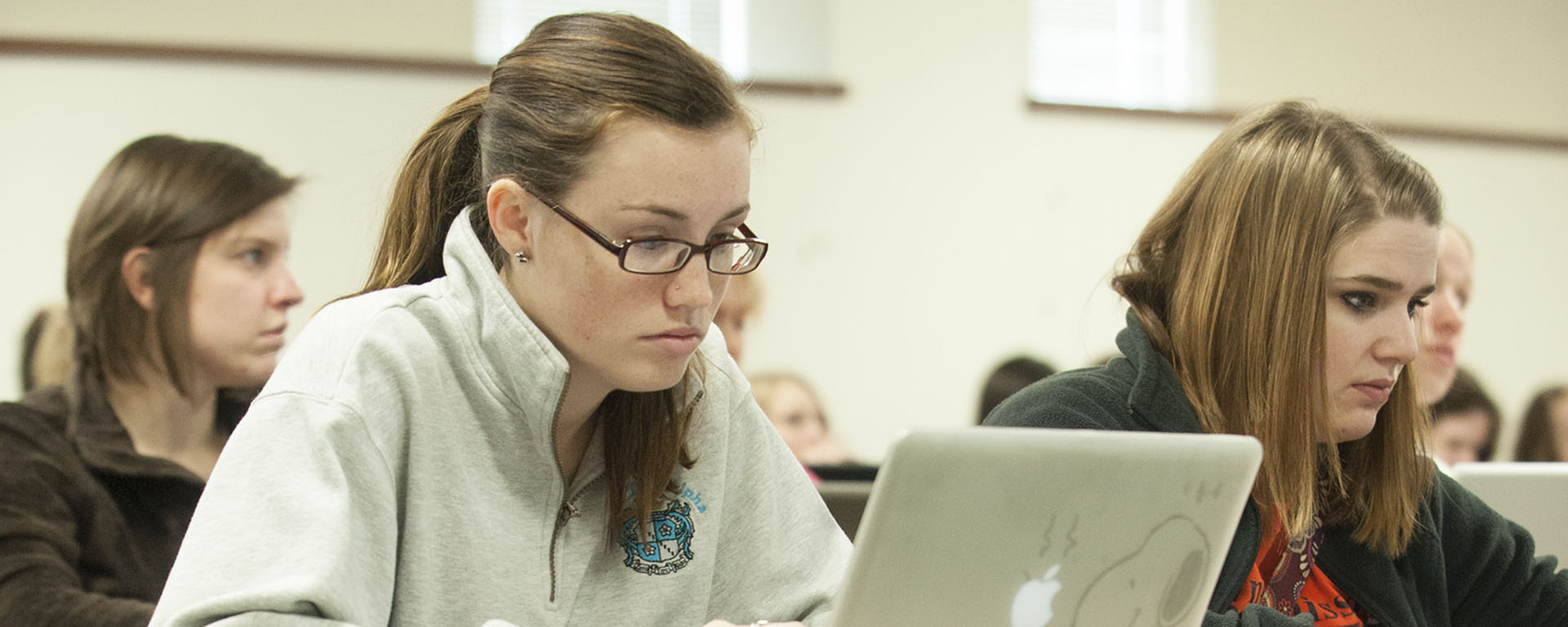 A Washburn student types on her laptop to take notes during class