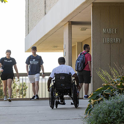 A student uses a wheelchair on campus.