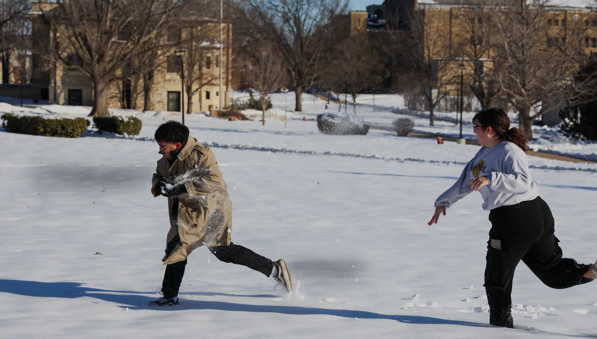 Students play in the snow on campus.