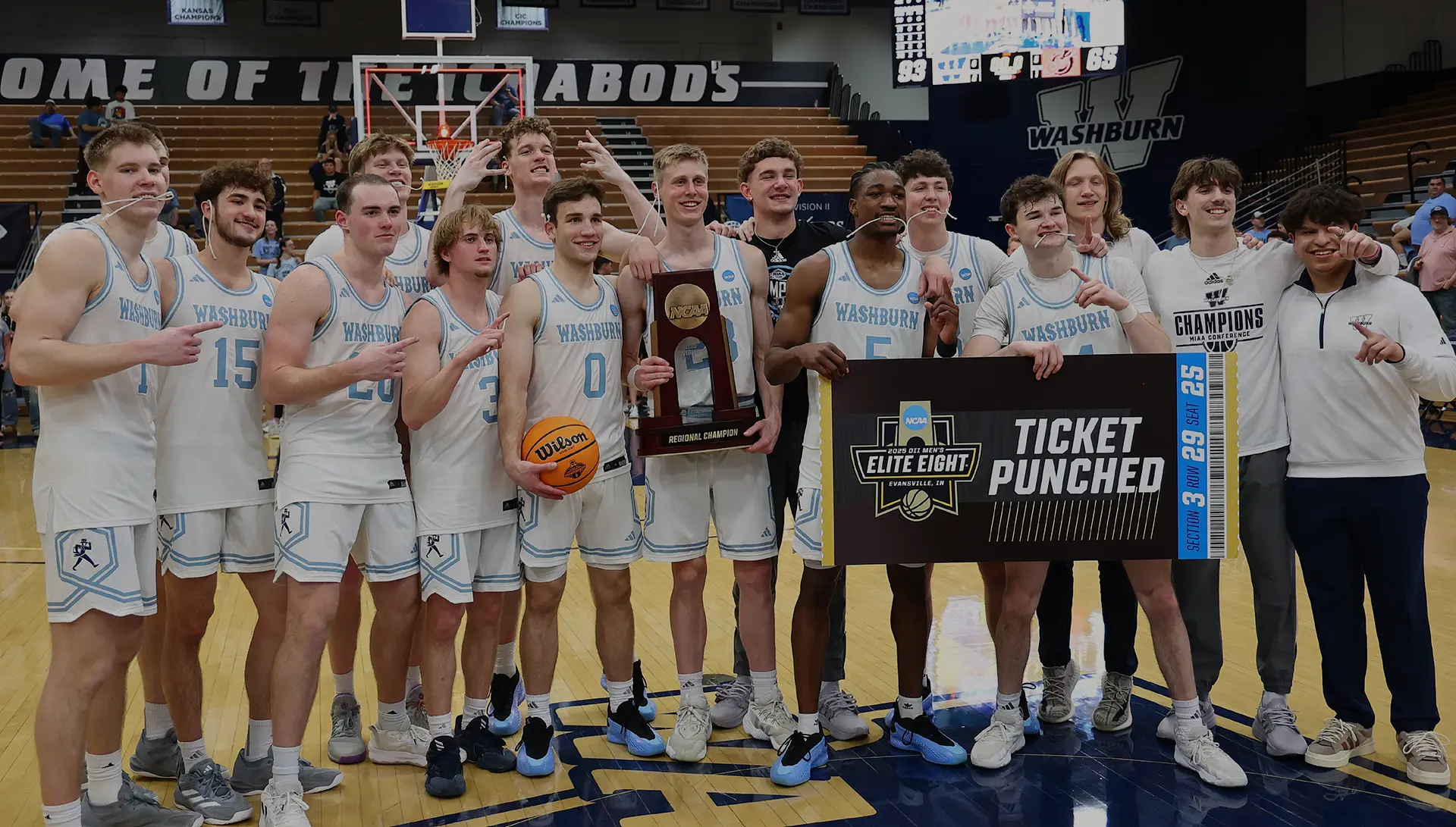 Basketball team poses with regional championship trophy.