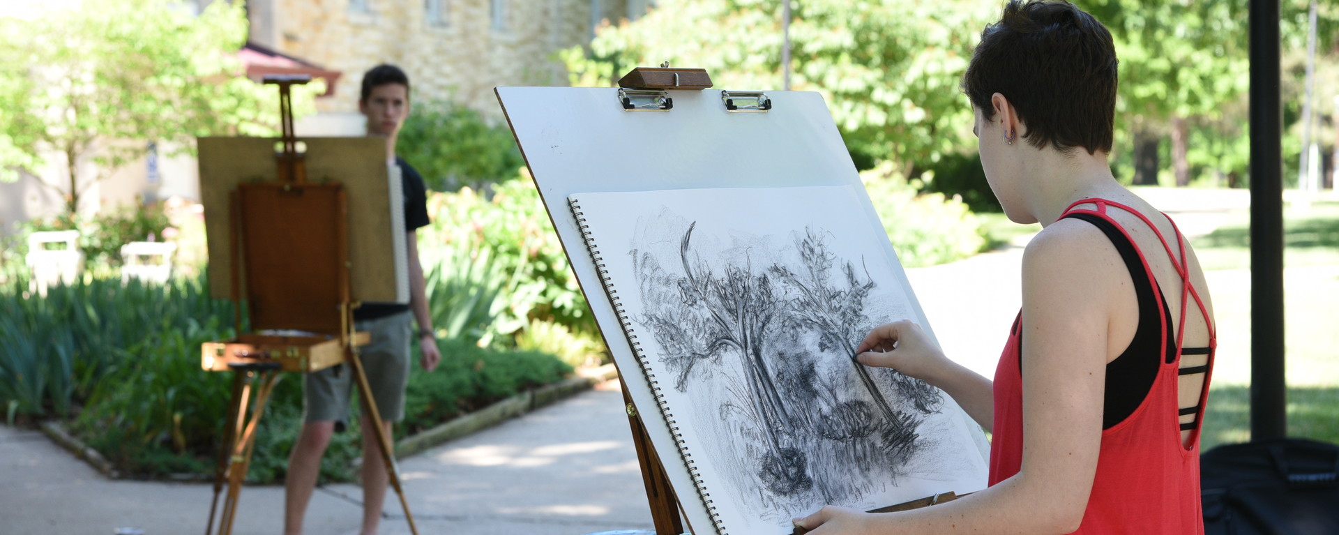 Students drawing outside on campus