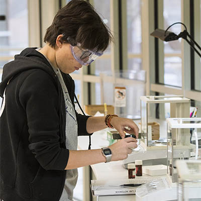 A student performs an experiment in a lab