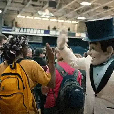 student high-fives Ichabod mascot at event