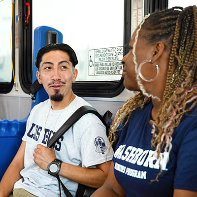 two students on city bus talking