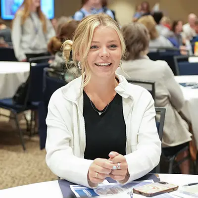 A student smiles while attending new student orientation.