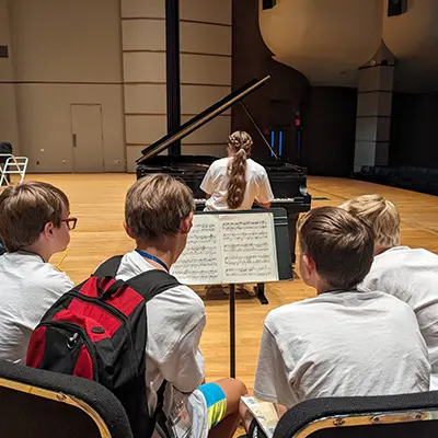 A group of campers play instruments in White Concert Hall.