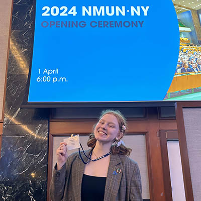 Chloe Chaffin smiles for a photo with her badge at the international model UN meeting.