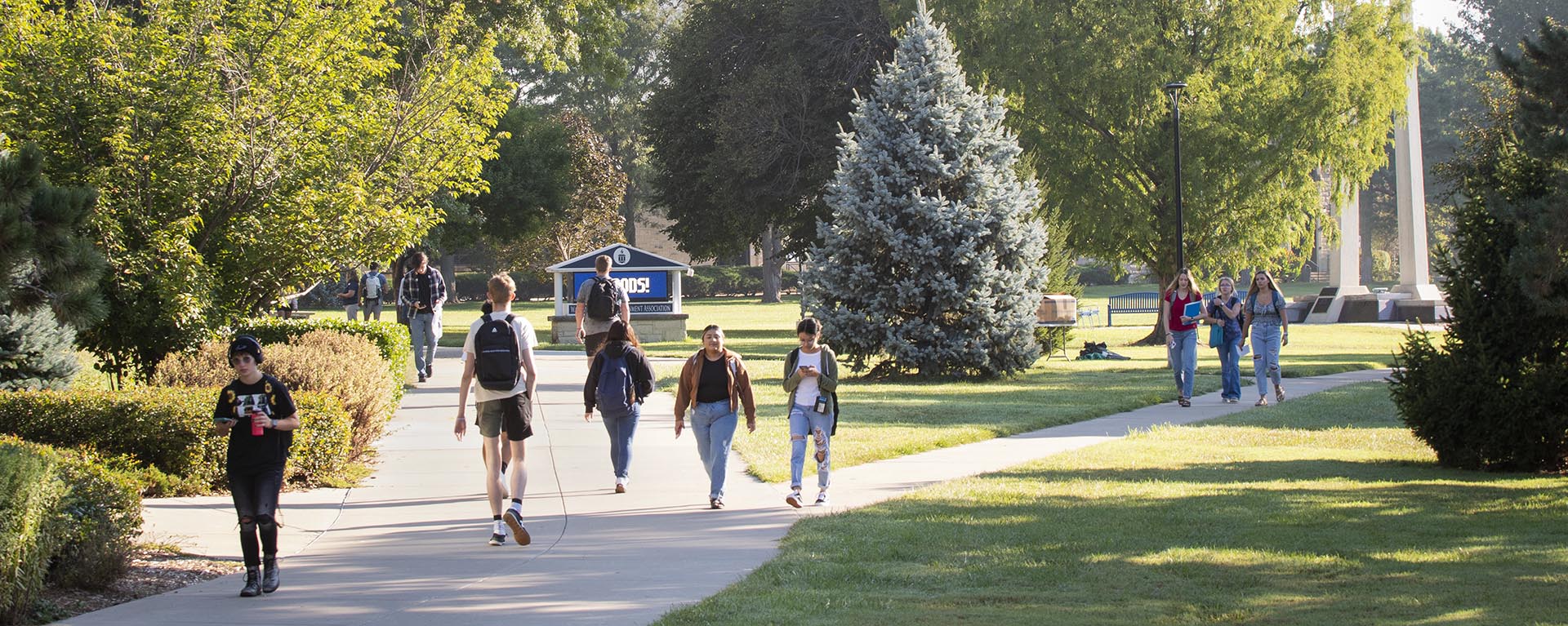 Students walk to class on campus on a spring day.