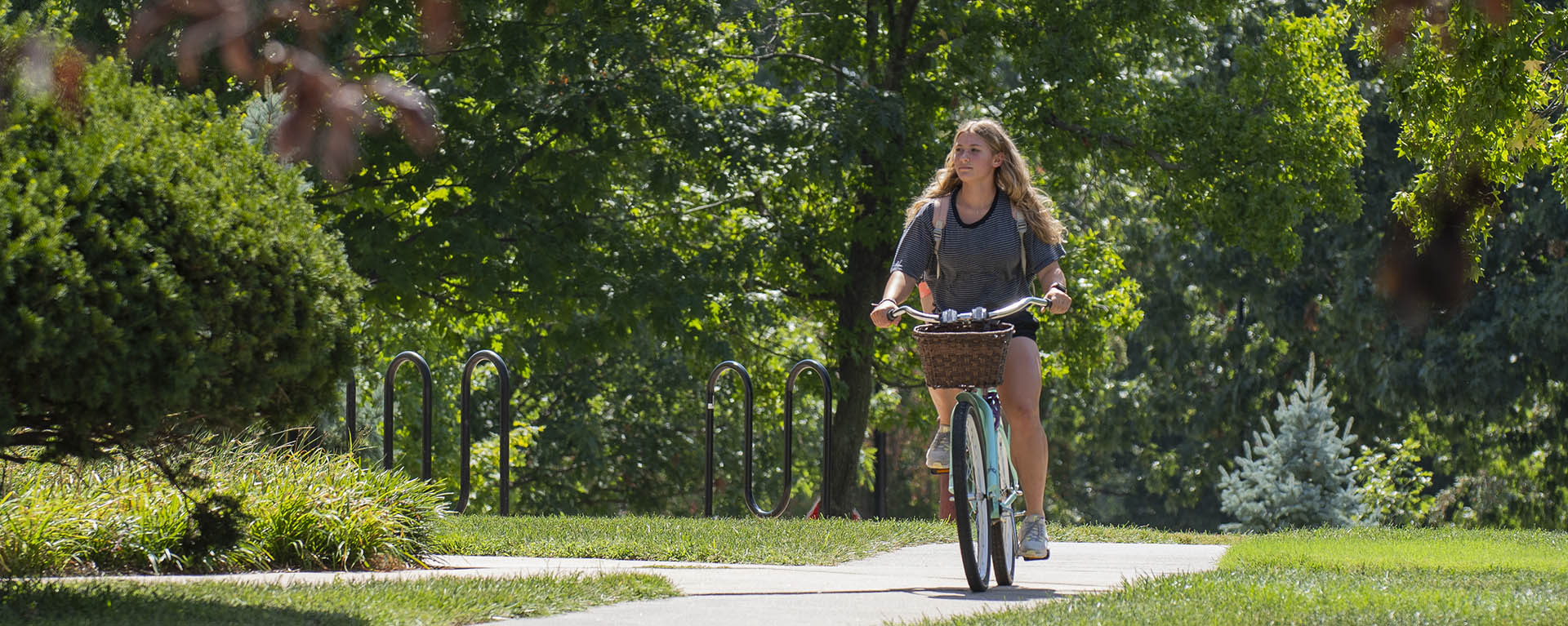 A student rides their bike on campus.