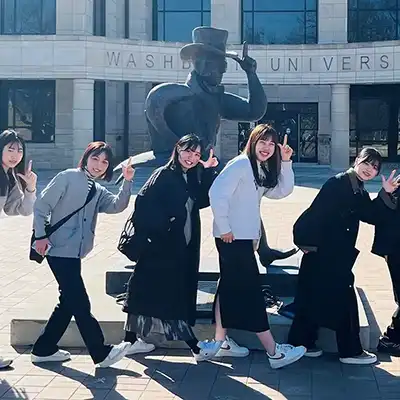 international students holding flags walking on campus