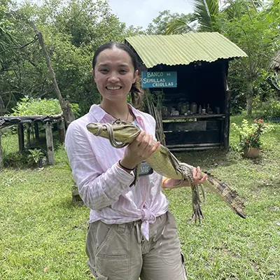 Khamphouy poses with an aligator.