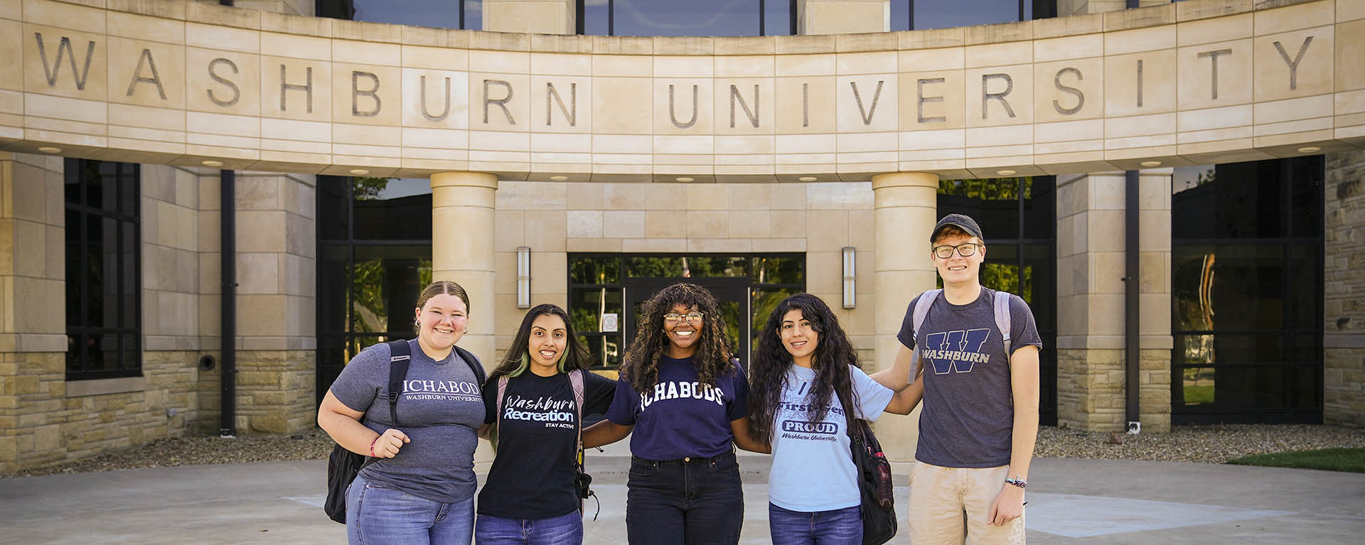 A group of Washburn students pose for a photo at Morgan Hall.