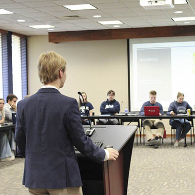 A student speaks from a podium in front of the WSGA.