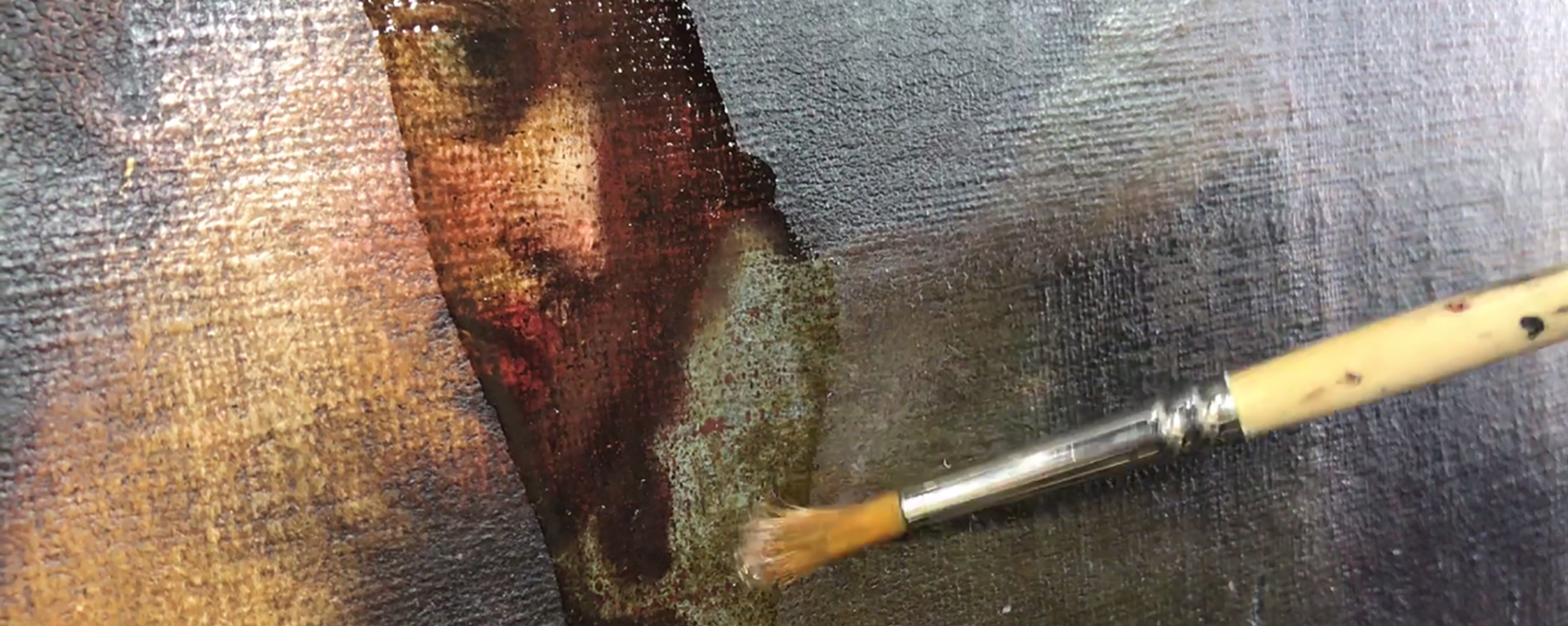  closeup photo of a paint brush cleaning a painting